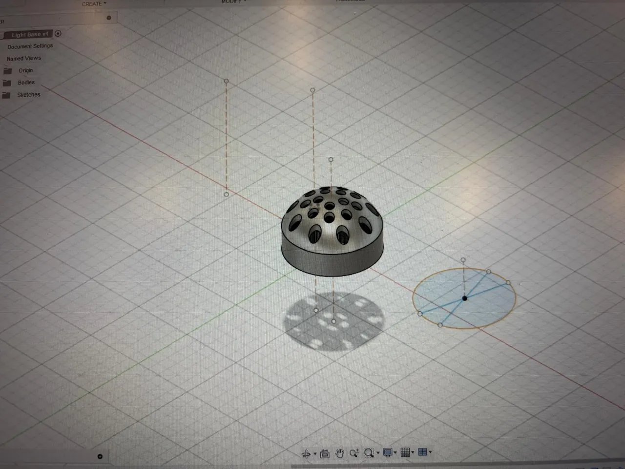 Domed light base model with a pattern of holes, designed in Fusion 360